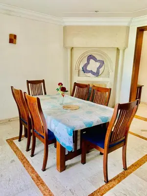 a dining room with a table with chairs and a fireplace at Rabat Hay Riad 3 Ideal Rooms in Rabat