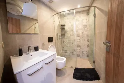 a bathroom with a toilet and a sink and a shower at NESK STAY Gauthier in Casablanca