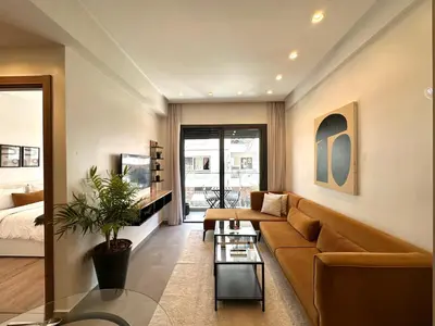 a living room with a couch and a table at NESK STAY Gauthier in Casablanca
