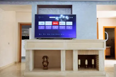 a flat screen tv sitting on top of a fireplace at Villa 130 Spacieuse 4 chambres dar bouazza proche plage in Casablanca