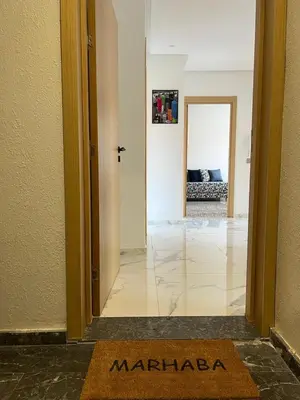 a welcome mat on the floor of a hallway at Relaxing Stay 3 Pools & Beach in Sidi Rahal