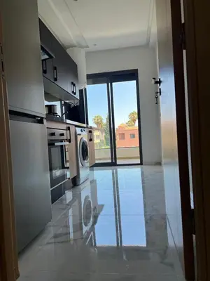 a kitchen with a washer and dryer on a tile floor at Relaxing Stay 3 Pools & Beach in Sidi Rahal