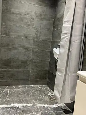 a bathroom with a shower with a shower curtain at Relaxing Stay 3 Pools & Beach in Sidi Rahal
