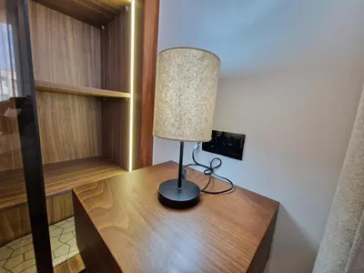 a lamp on a wooden desk in a room at Cosy stylé et confortable in Casablanca