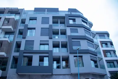 a tall apartment building with a blue at Cosy stylé et confortable in Casablanca