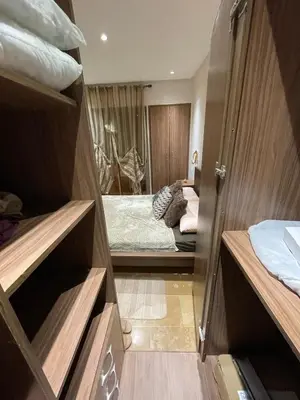 a room with a bedroom with a bed and a room with a bed sqor at Beautiful apartment with pool in Mansouria