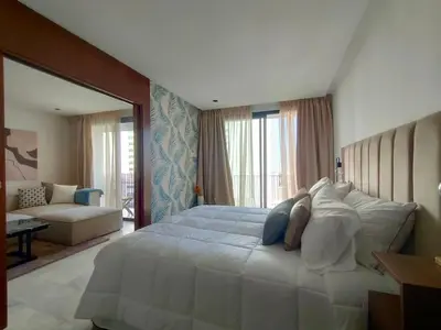 a woman laying on a large bed in a bedroom at Beautiful Apartment, Great Location, Fiber Optic in Casablanca
