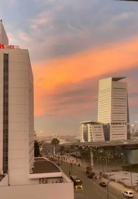 a city with tall buildings and a street with traffic at Beautiful Apartment, Great Location, Fiber Optic in Casablanca
