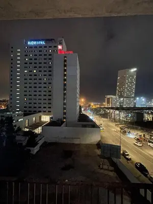 a view of a city at night with a building at Beautiful Apartment, Great Location, Fiber Optic in Casablanca