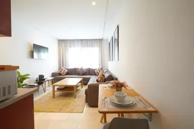 a living room with a couch and a table at Beautiful 1 Bedroom in the Center of Casablanca in Casablanca