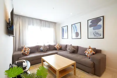 a living room with a couch and a table at Beautiful 1 Bedroom in the Center of Casablanca in Casablanca