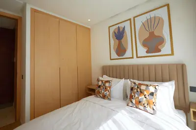 a bedroom with a bed and some pictures on the wall at Beautiful 1 Bedroom in the Center of Casablanca in Casablanca