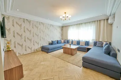 a living room with blue couches and a table at 3 Bedrooms and Room Balcony in Central Casablanca in Casablanca