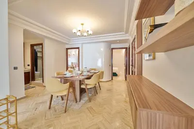 a dining room with a wooden table and chairs at 3 Bedrooms and Room Balcony in Central Casablanca in Casablanca