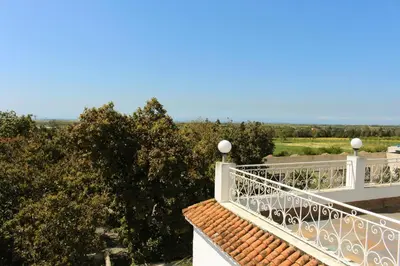 a balcony of a house with trees in the background at Casa Palma Morocco in Sidi Yahia az Zaʼer