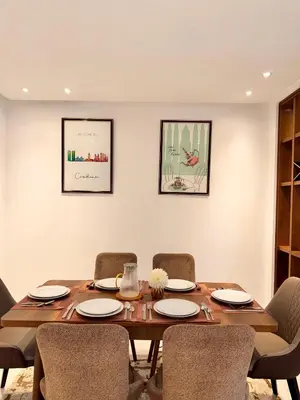 a dining room with a wooden table and chairs at Central 2 bedrooms in Casablanca in Casablanca