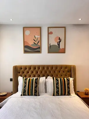 a bedroom with a bed with three pictures on the wall at Central 2 bedrooms in Casablanca in Casablanca