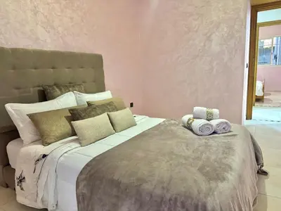 a bedroom with a large bed with towels on it at Spacious family accommodation in Rabat