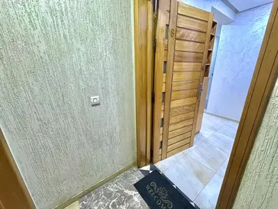a room with a wooden door and a hallway at Spacious family accommodation in Rabat