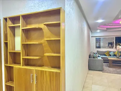 a room with wooden shelves in a living room at Spacious family accommodation in Rabat