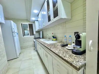 a kitchen with a counter top and a refrigerator at Spacious family accommodation in Rabat