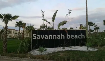a sign for the savannah beach resort at Magnificent Luxury Beach Villa in Savannah Beach in Dar Hamida