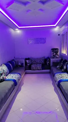 a room with two beds and purple lights at 50m RDC aliace darna louizia in Mohammedia