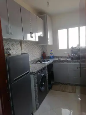 a kitchen with a refrigerator and a washing machine at 50m RDC aliace darna louizia in Mohammedia