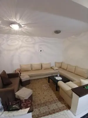 a living room with a couch and a table at Maison agdal 2 chambres salon in Rabat