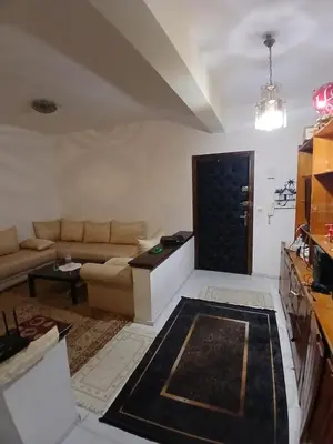 a living room with a couch and a table at Maison agdal 2 chambres salon in Rabat