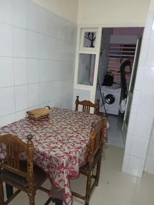 a table and chairs in a kitchen with a window at Maison agdal 2 chambres salon in Rabat