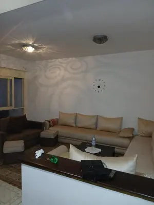a living room with a couch and a table at Maison agdal 2 chambres salon in Rabat