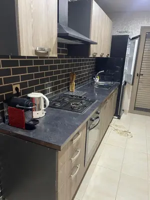 a kitchen with a black counter top with a stove at Sunny modern Apartment- Ocean & Pool view in Al Mansouria in Mansouria
