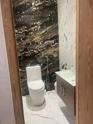 a bathroom with a white toilet and a sink at Sunny modern Apartment- Ocean & Pool view in Al Mansouria in Mansouria