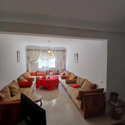 a living room with couches and a red table at Residence Les jardins de Belvedere in Casablanca