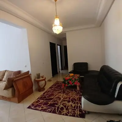 a living room with two chairs and a couch at Residence Les jardins de Belvedere in Casablanca