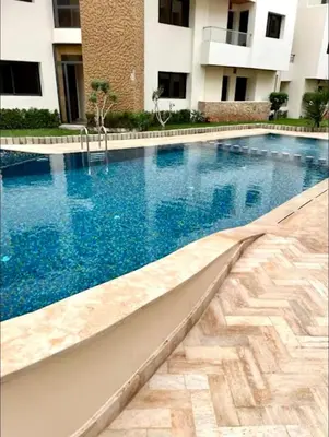 a large swimming pool in front of a building at Sweethome in Bouznika