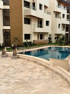 a swimming pool in front of a building at Sweethome in Bouznika