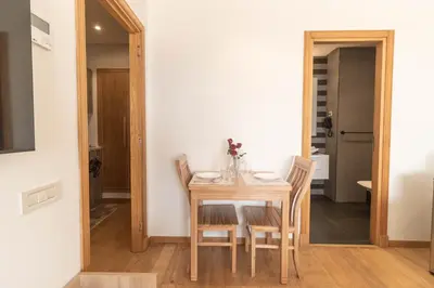 a dining room with a wooden table and chairs at Panorama sur l'infini in Casablanca