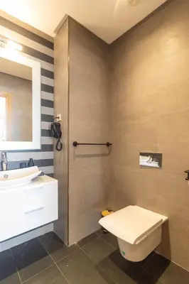 a bathroom with a toilet and a sink at Panorama sur l'infini in Casablanca