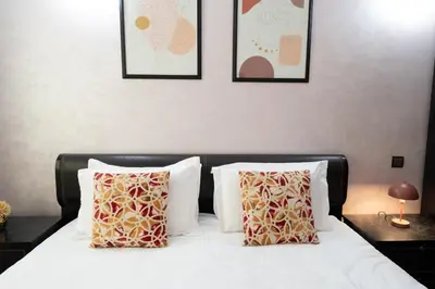 a bedroom with a bed with four pictures on the wall at Large & Comfy 3 bedrooms in Casablanca Center in Casablanca