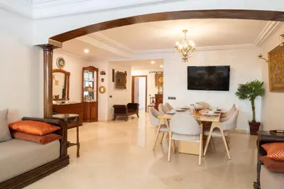 a living room with a table and a dining room at Large & Comfy 3 bedrooms in Casablanca Center in Casablanca