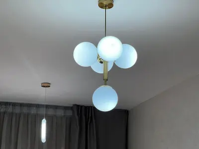 two white lights hanging from a ceiling at Nice studio in Rabat