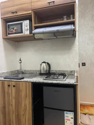 a small kitchen with a stove and a microwave at Nice studio in Rabat