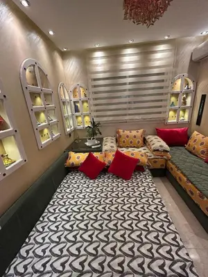 a room with a couch and a table and windows at Apartment Romandie in Casablanca