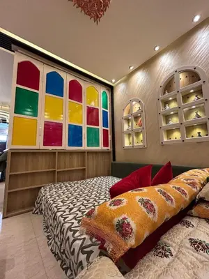 a bedroom with a bed and colorful windows at Apartment Romandie in Casablanca