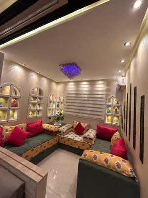 a living room with a large couch and red pillows at Apartment Romandie in Casablanca