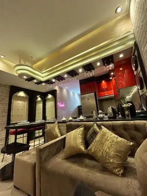 a living room with a couch and a kitchen at Apartment Romandie in Casablanca