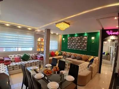 a living room with a couch and a table at Superbe appartement corniche in Casablanca