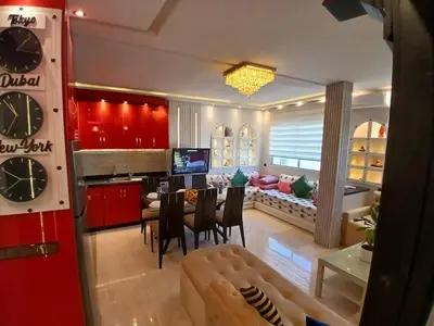 a living room with a couch and a dining room at Superbe appartement corniche in Casablanca